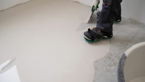 Spreading and leveling concrete floor