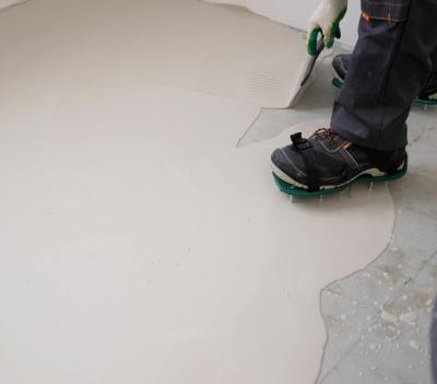 person with special shoes putting epoxy on a concrete floor